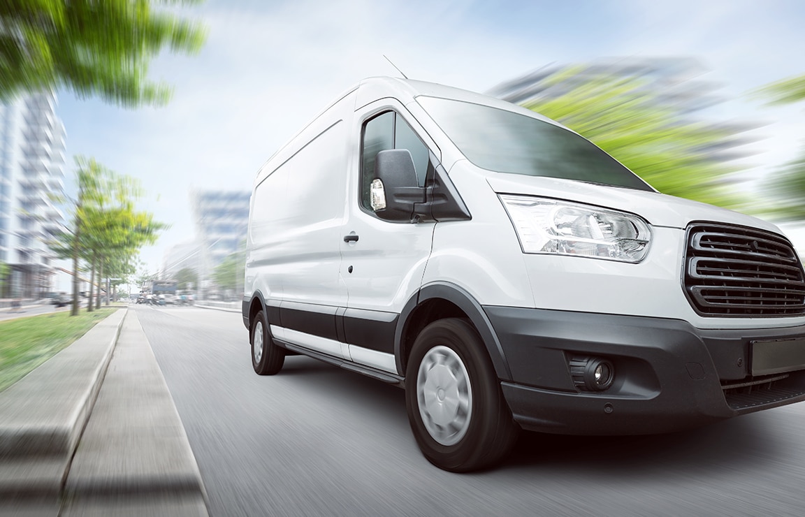 a white van driving down the road