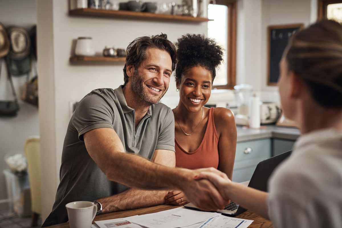 a man shaking hands with a woman 
