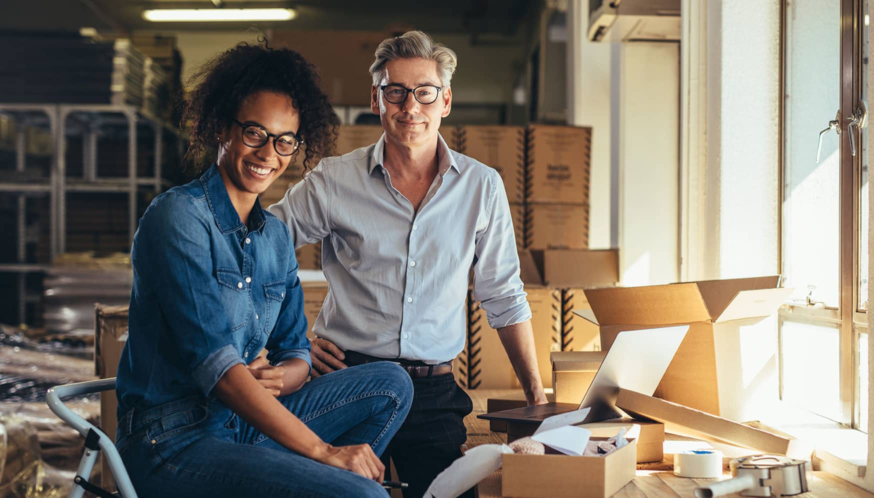 A man and woman packing boxes