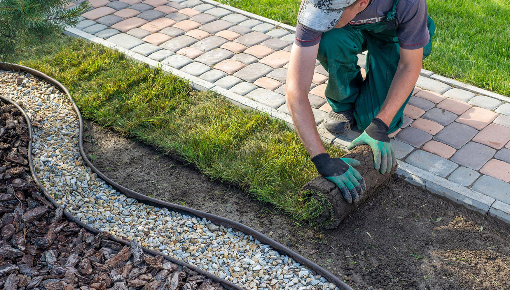 A landscaper laying down sod