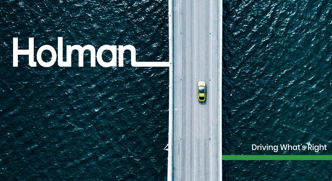 a car driving on a bridge over water