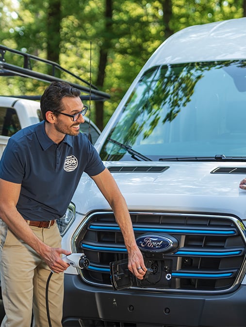 a man holding a charging station next to a woman