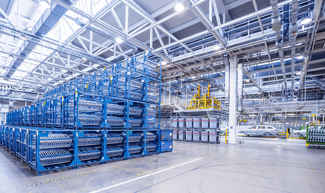 a large warehouse with blue shelves and a car