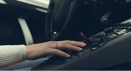 a hand on a car keypad