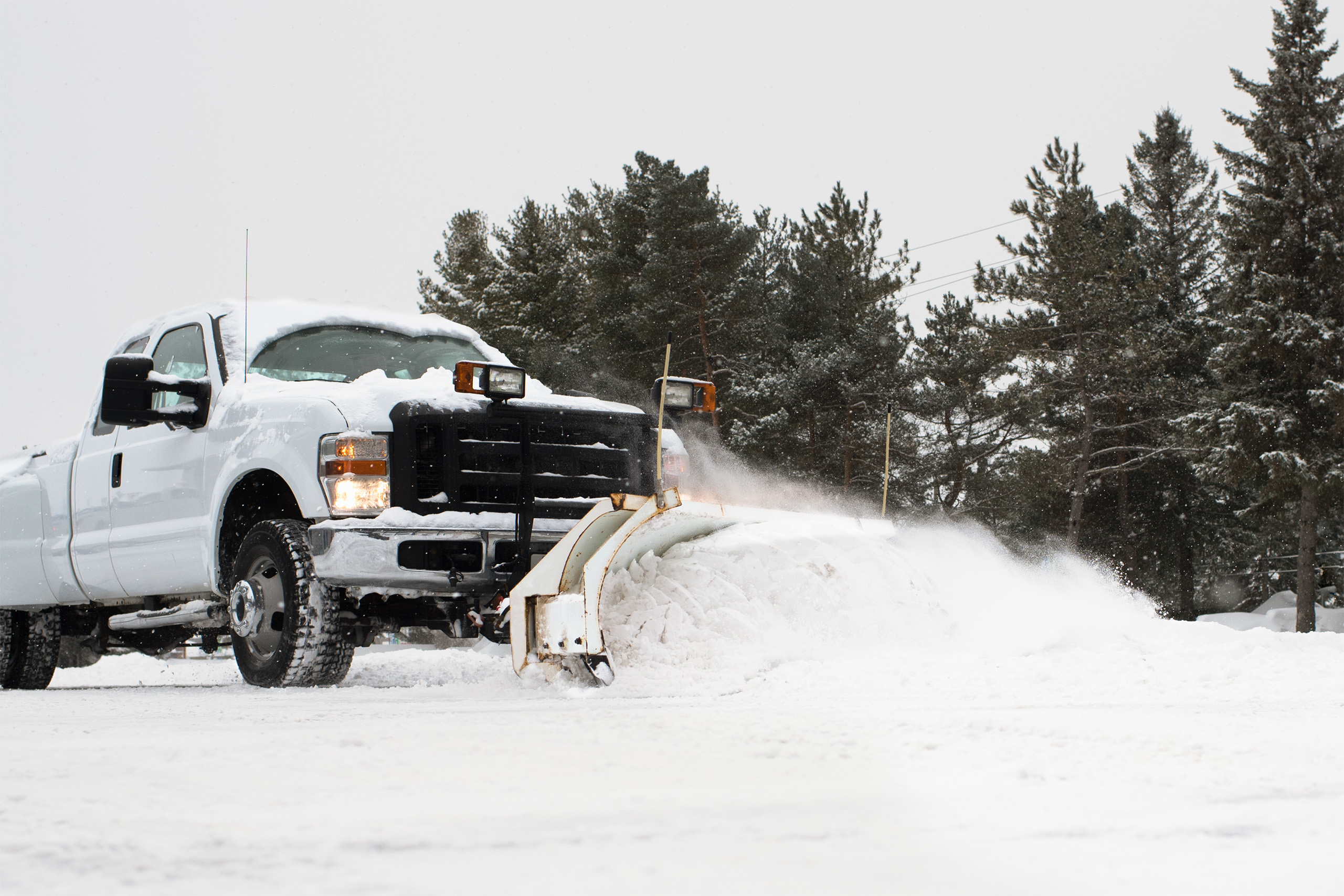 a snow plow removing snow from a truck