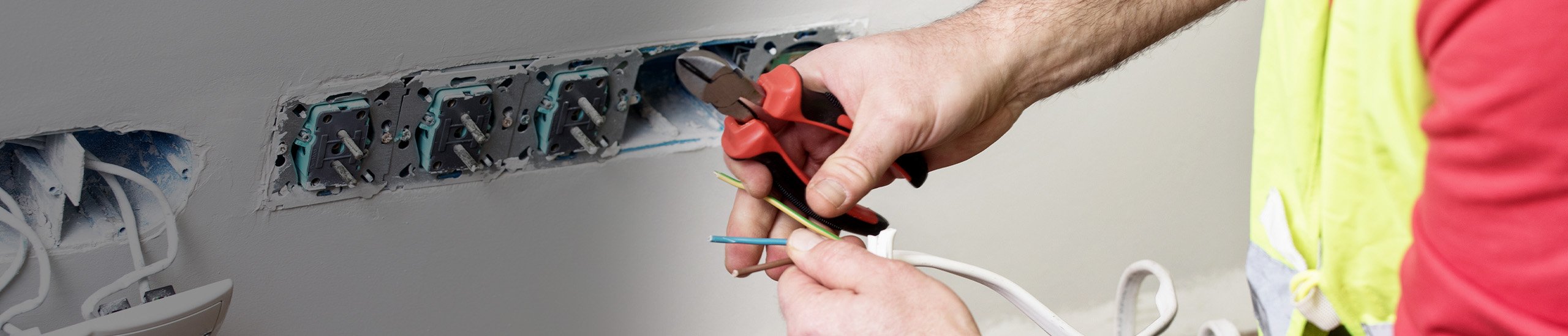 a person cutting wires with a pliers