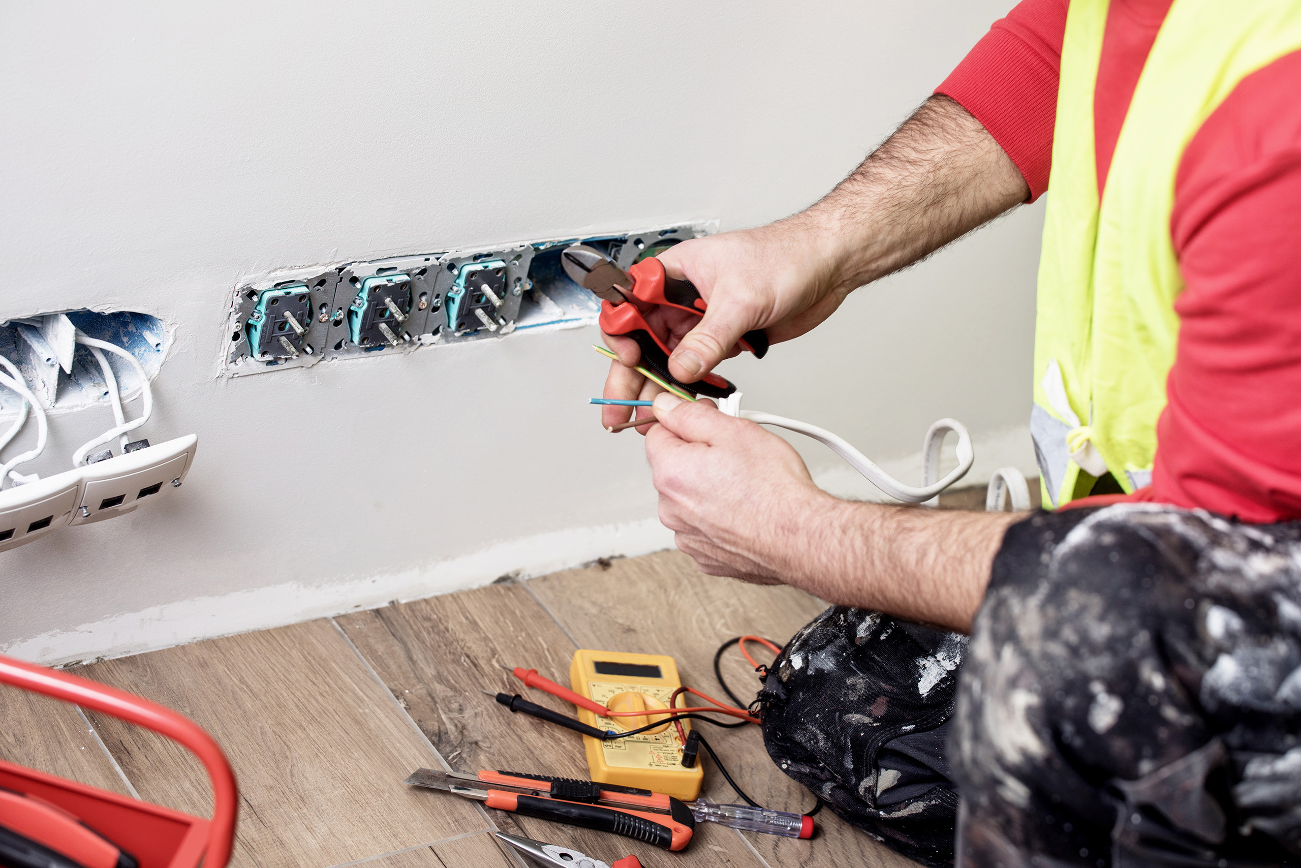 a man working on a electrical outlet