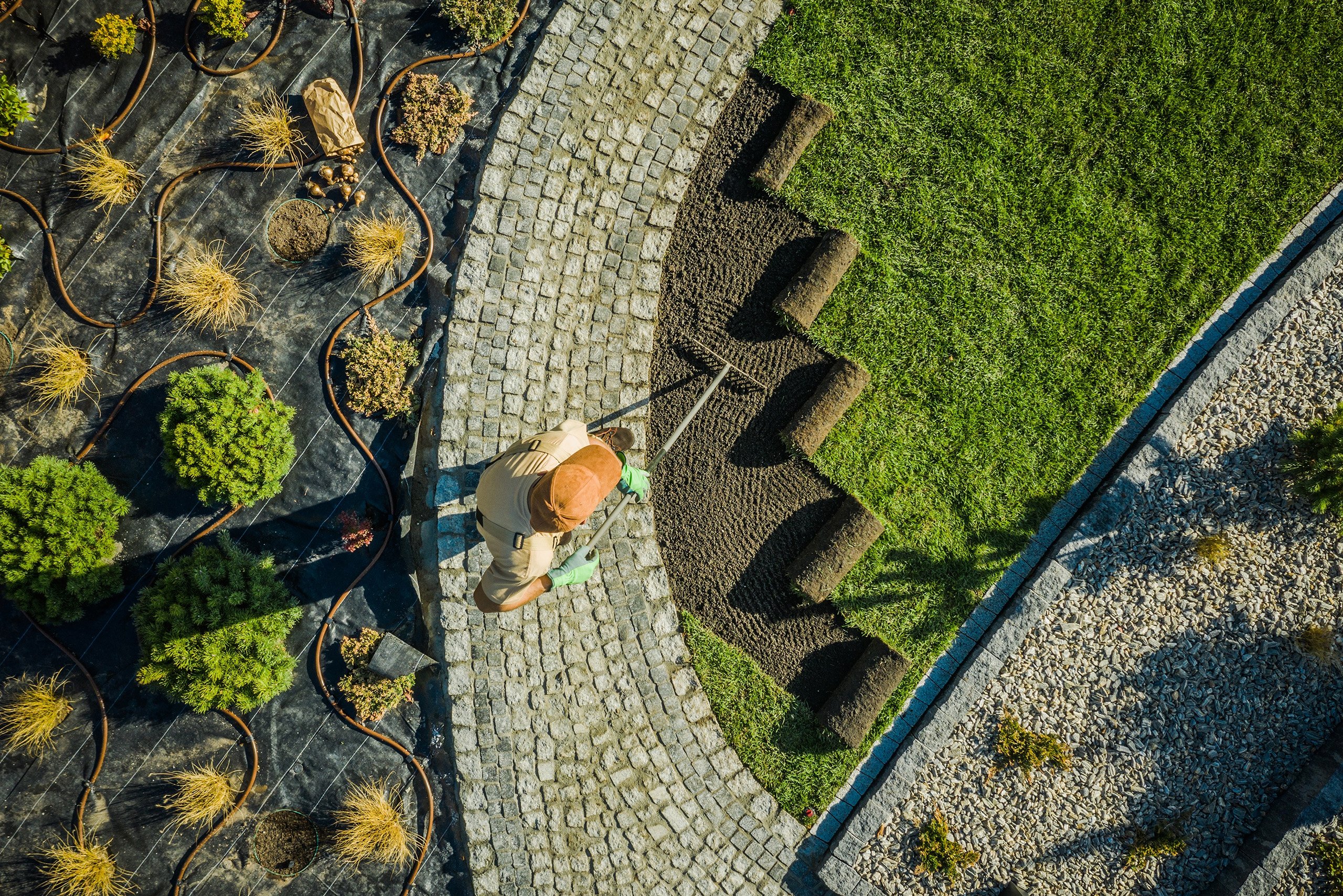 a person using a tool to trim the grass