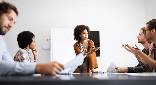 a woman giving a presentation to a group of people