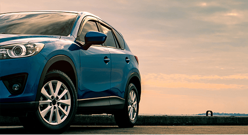 a blue car parked on a road