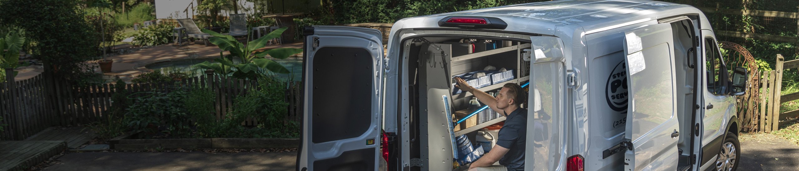 a person putting tools in the back of a van