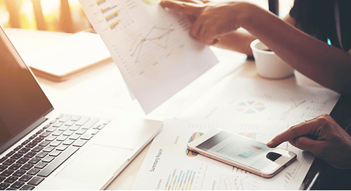 a person holding a paper and a phone