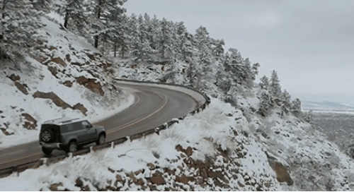 a car driving on a road in the snow