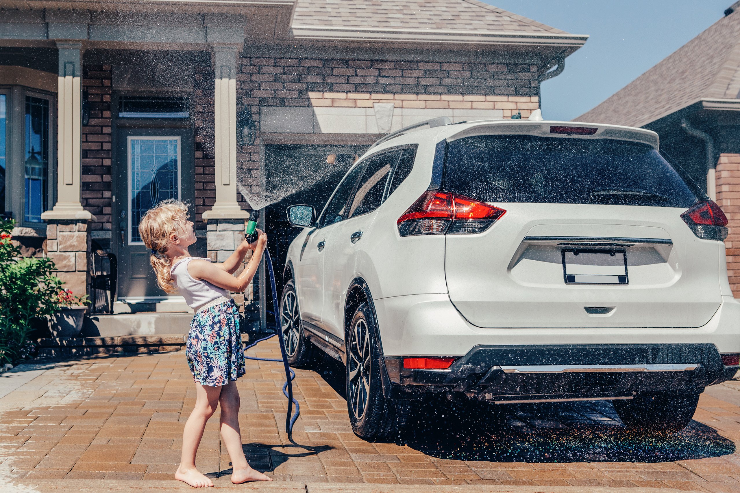 a girl washing a car