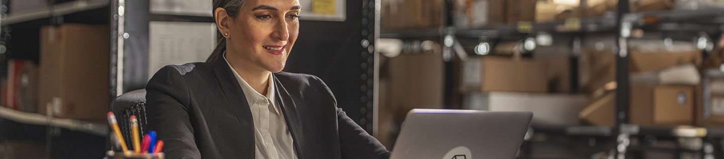 a woman in a suit looking at a laptop