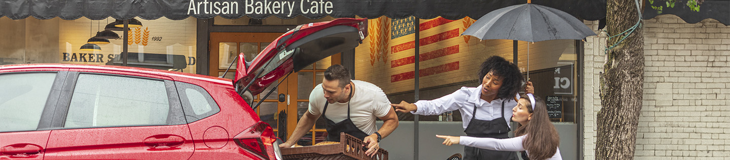 a man standing behind a car