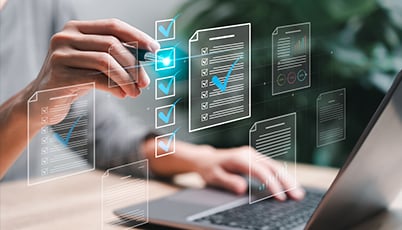 a person using a laptop with a pen