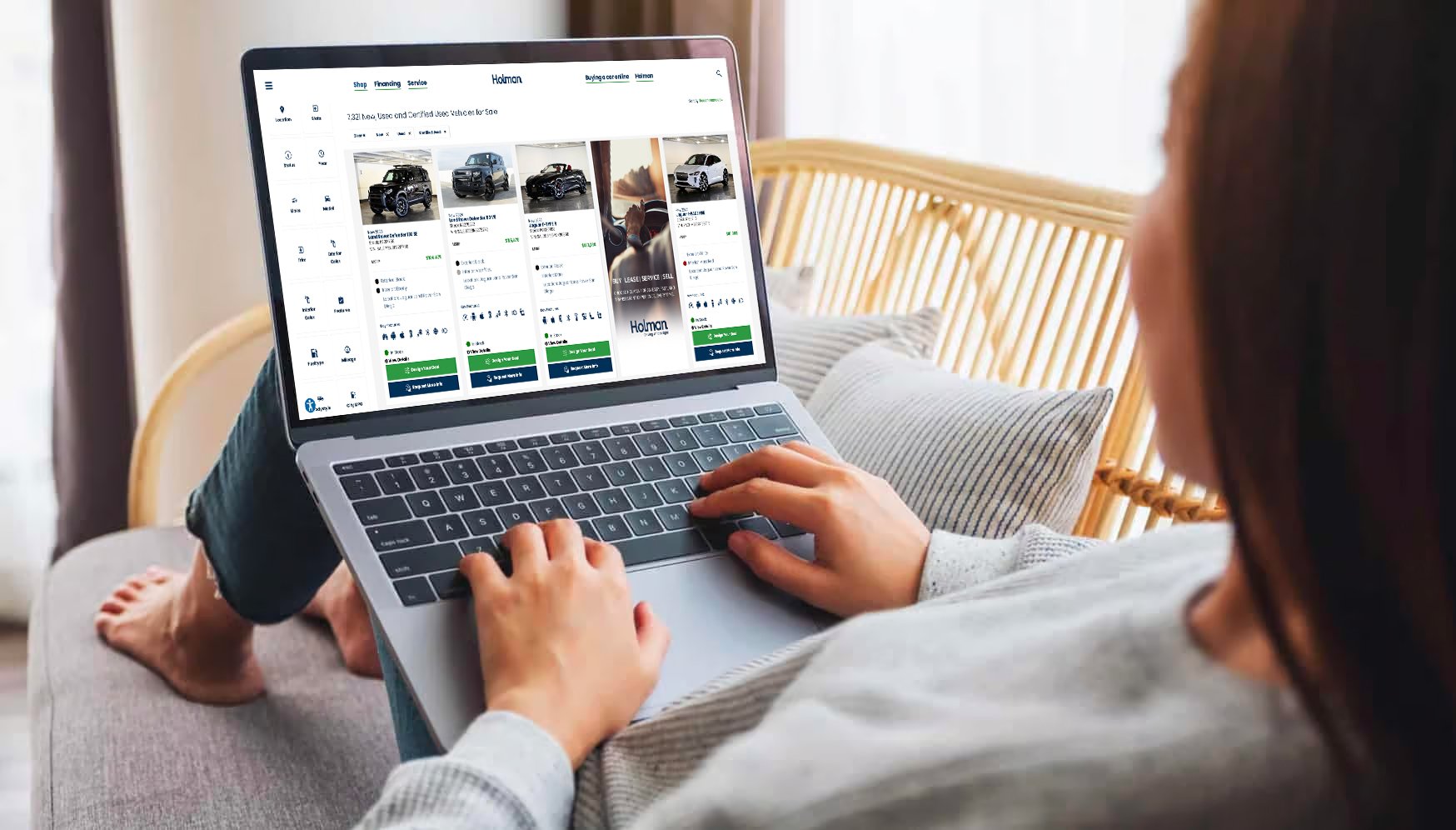 a person sitting on a couch using a laptop