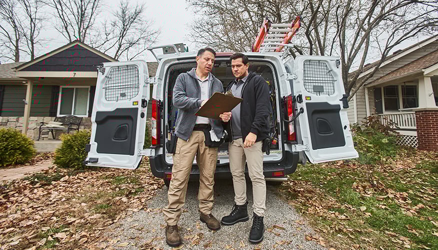 Two hvac professionals looking at a tablet