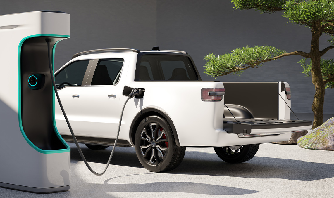 a white truck with a black bed and a green plant