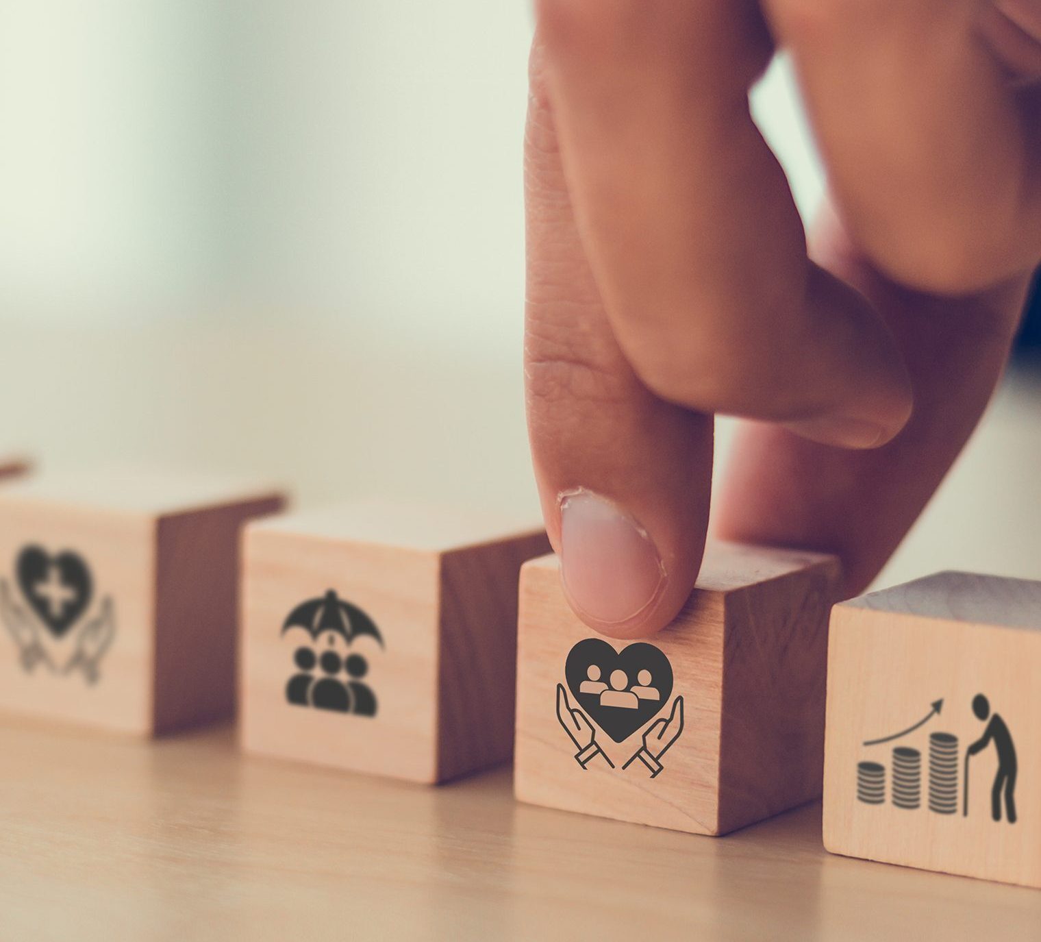 a finger touching a wooden block