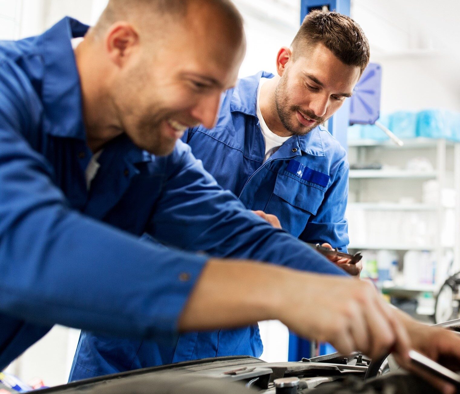 a group of men working on a car