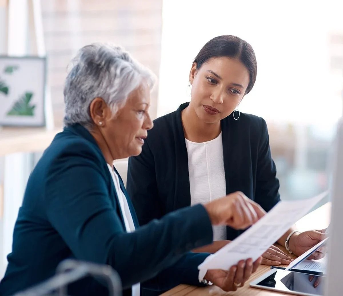 a woman showing a piece of paper to a woman