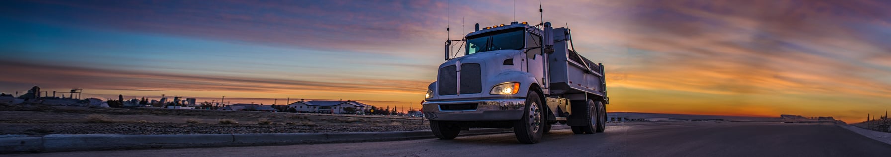 A heavy duty truck driving on a road