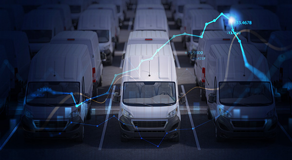 a row of white vans in a parking lot
