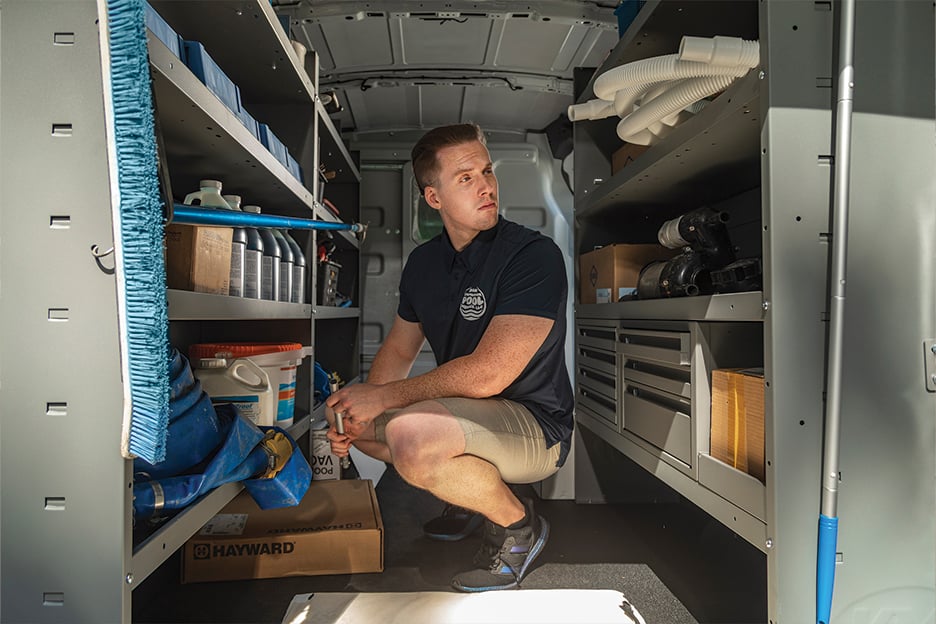 a man squatting in a van