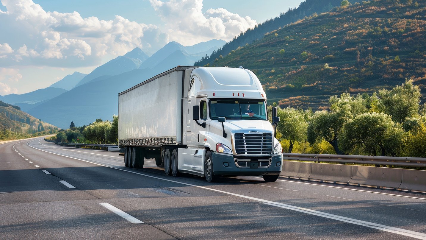 A tractor trailer driving on a mountain road