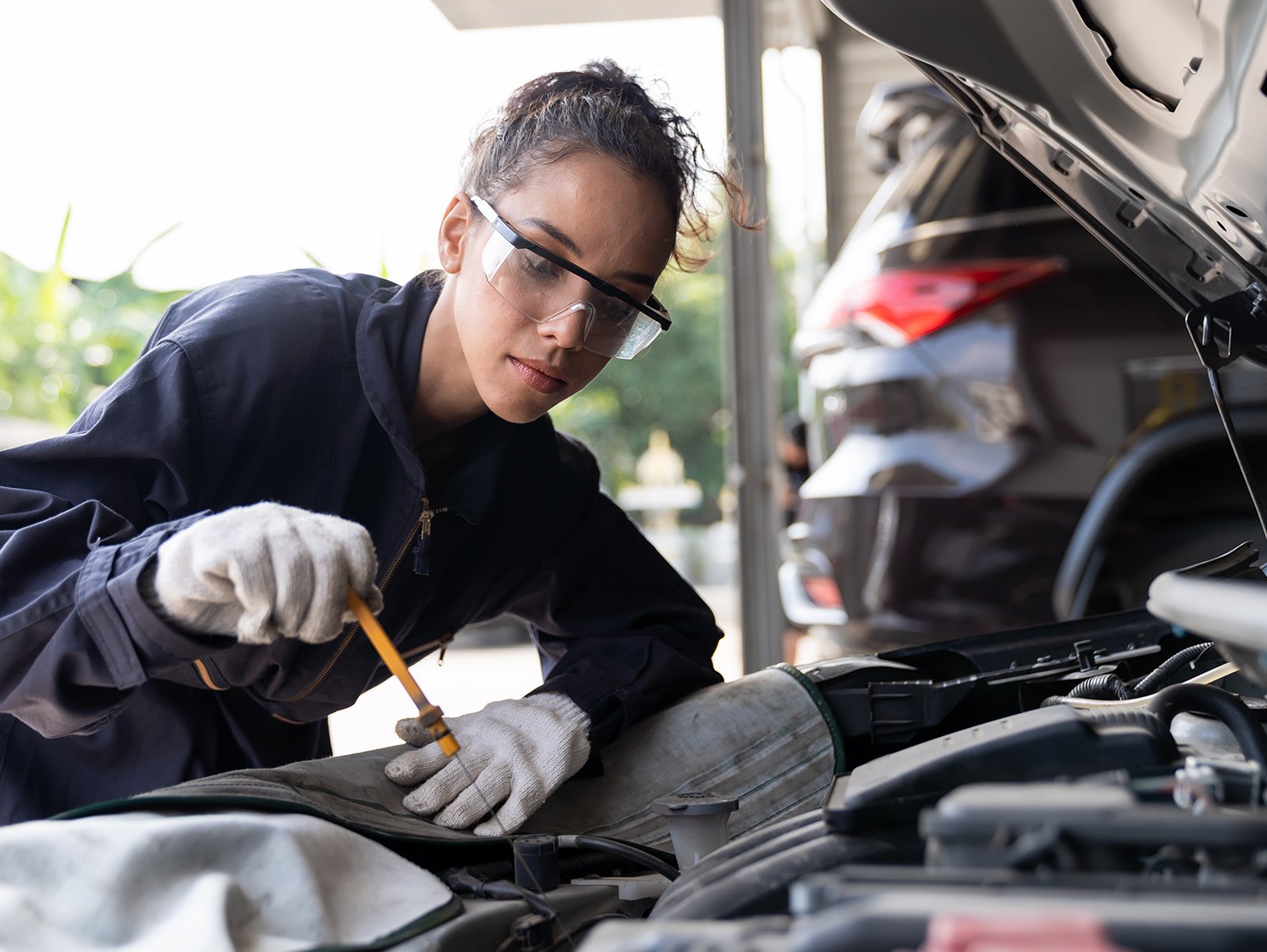a woman working on a car 