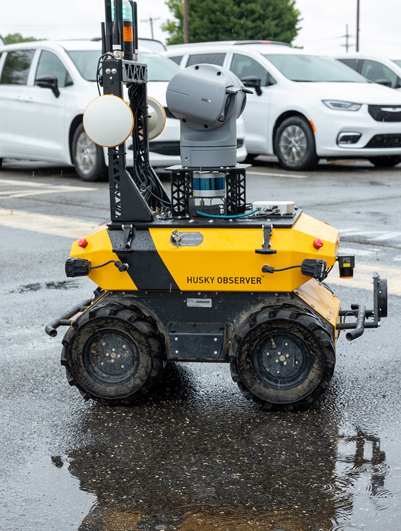Yellow robotic vehicle in parking lot