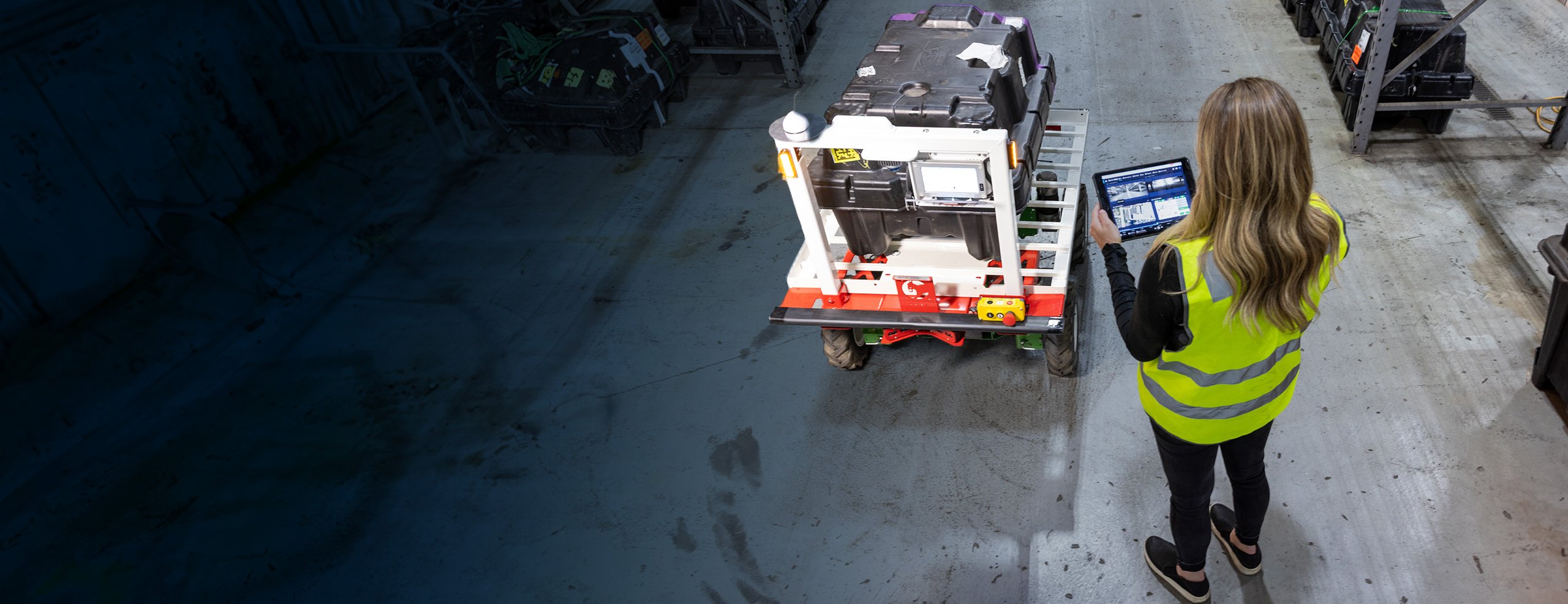 Woman in safety vest using tablet
