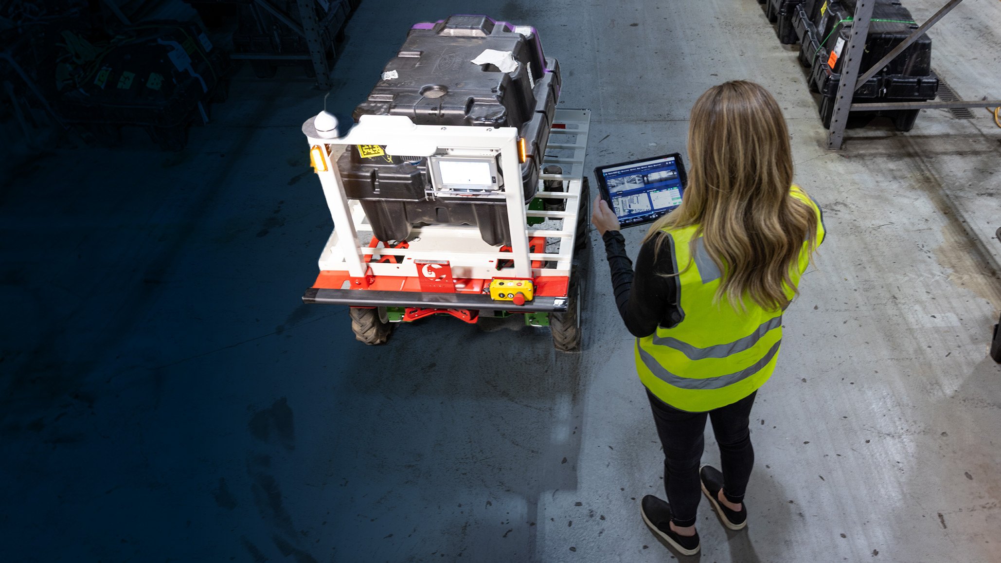 warehouse worker manager a robotic card from a computer