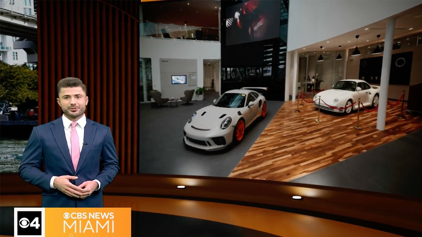 Man presenting cars in showroom
