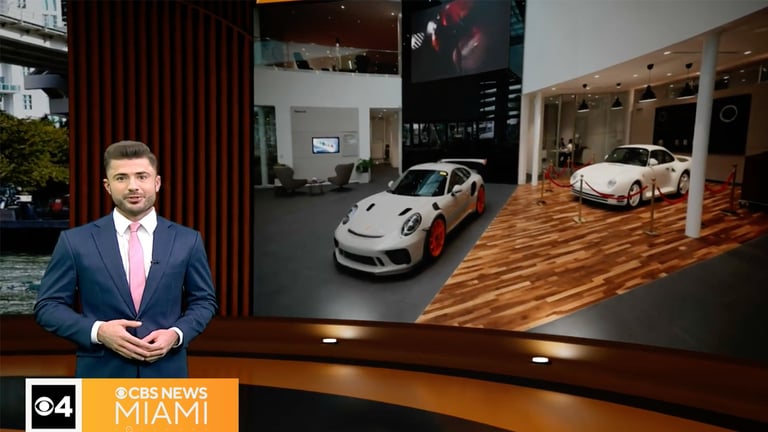 Man presenting cars in showroom