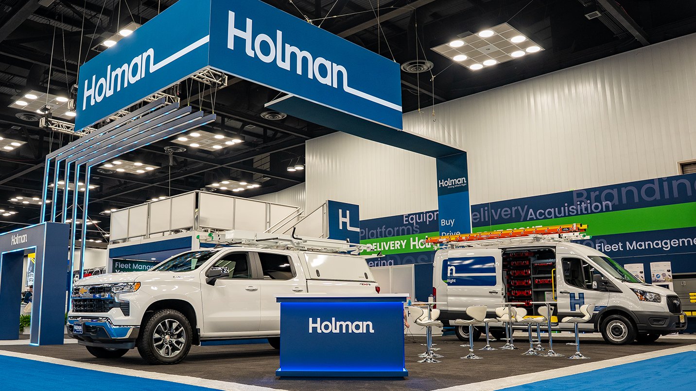 Trade show booth with vehicles displayed.