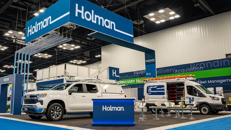 Trade show booth with vehicles displayed.