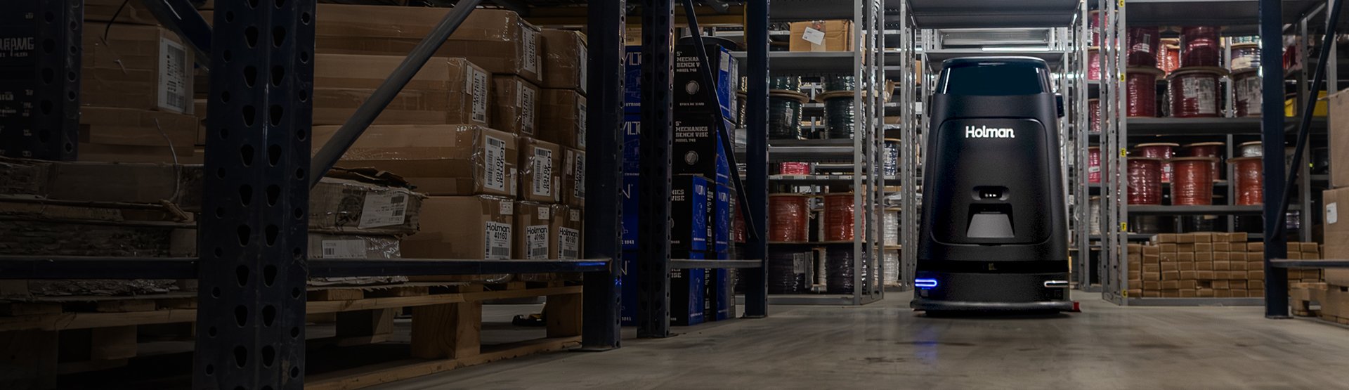 Autonomous robot in warehouse aisle.
