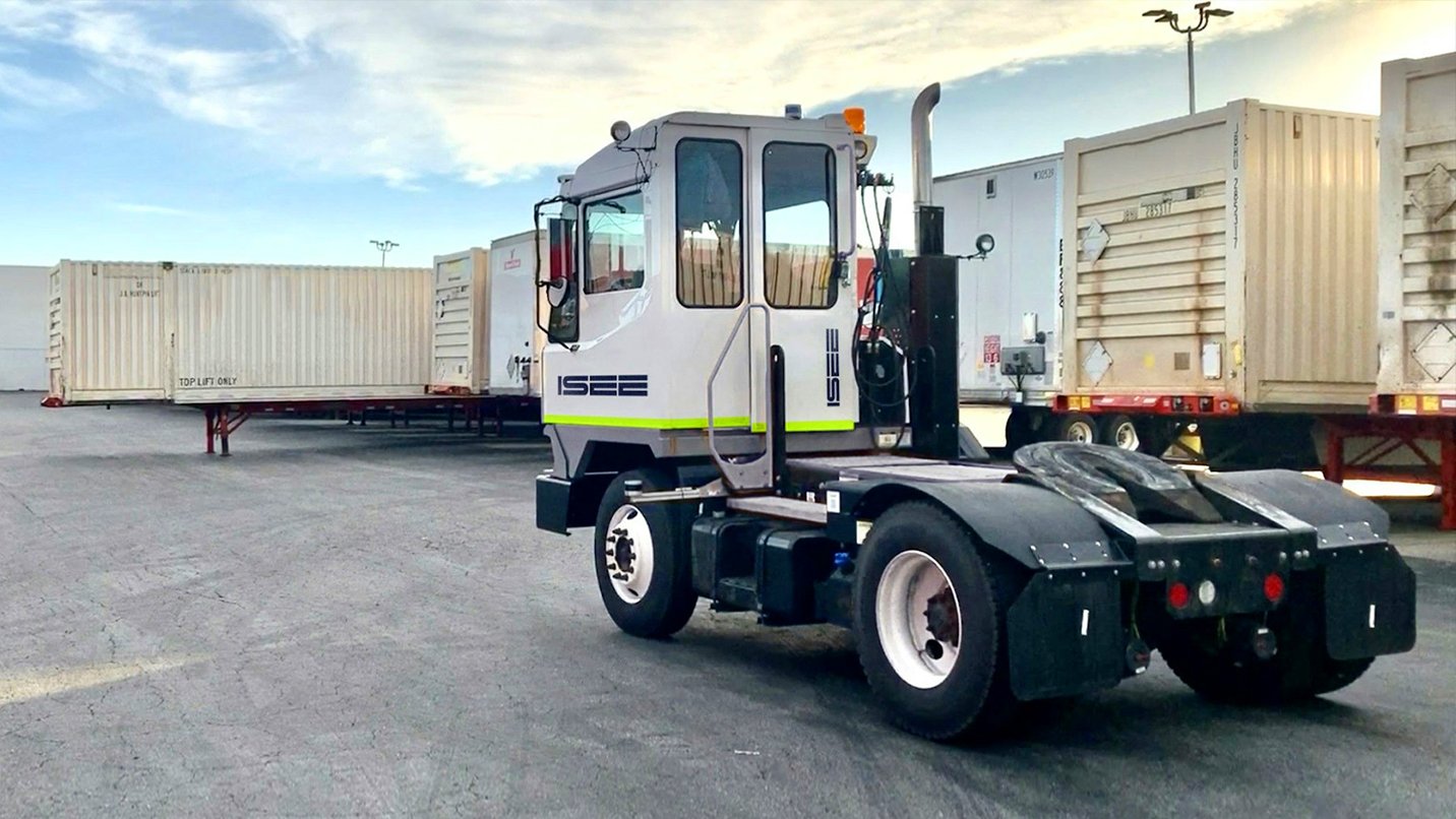 Truck near shipping containers in yard
