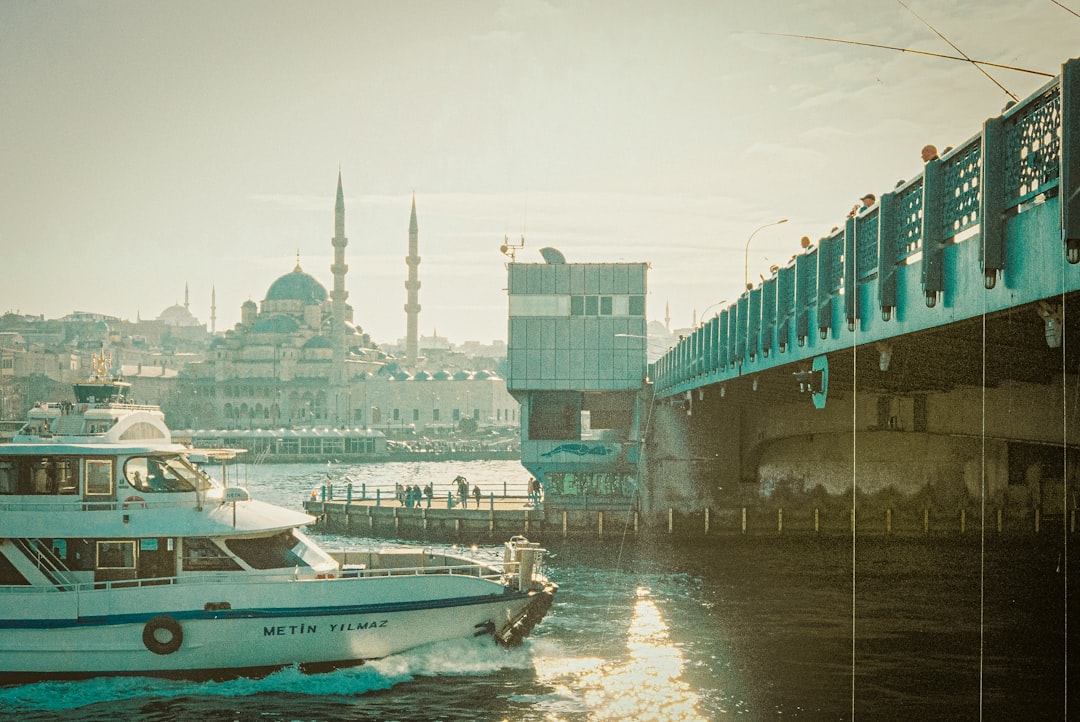 A traditional Turkish boat cruising the Bosphorus Strait with city views