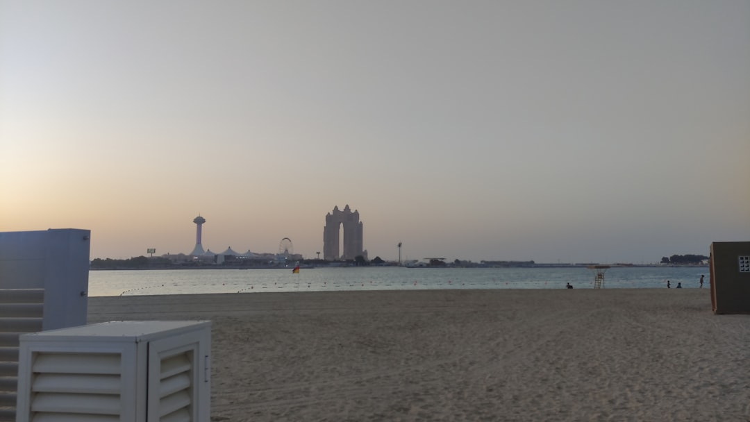 People cycling along the Abu Dhabi Corniche with skyscrapers in the background