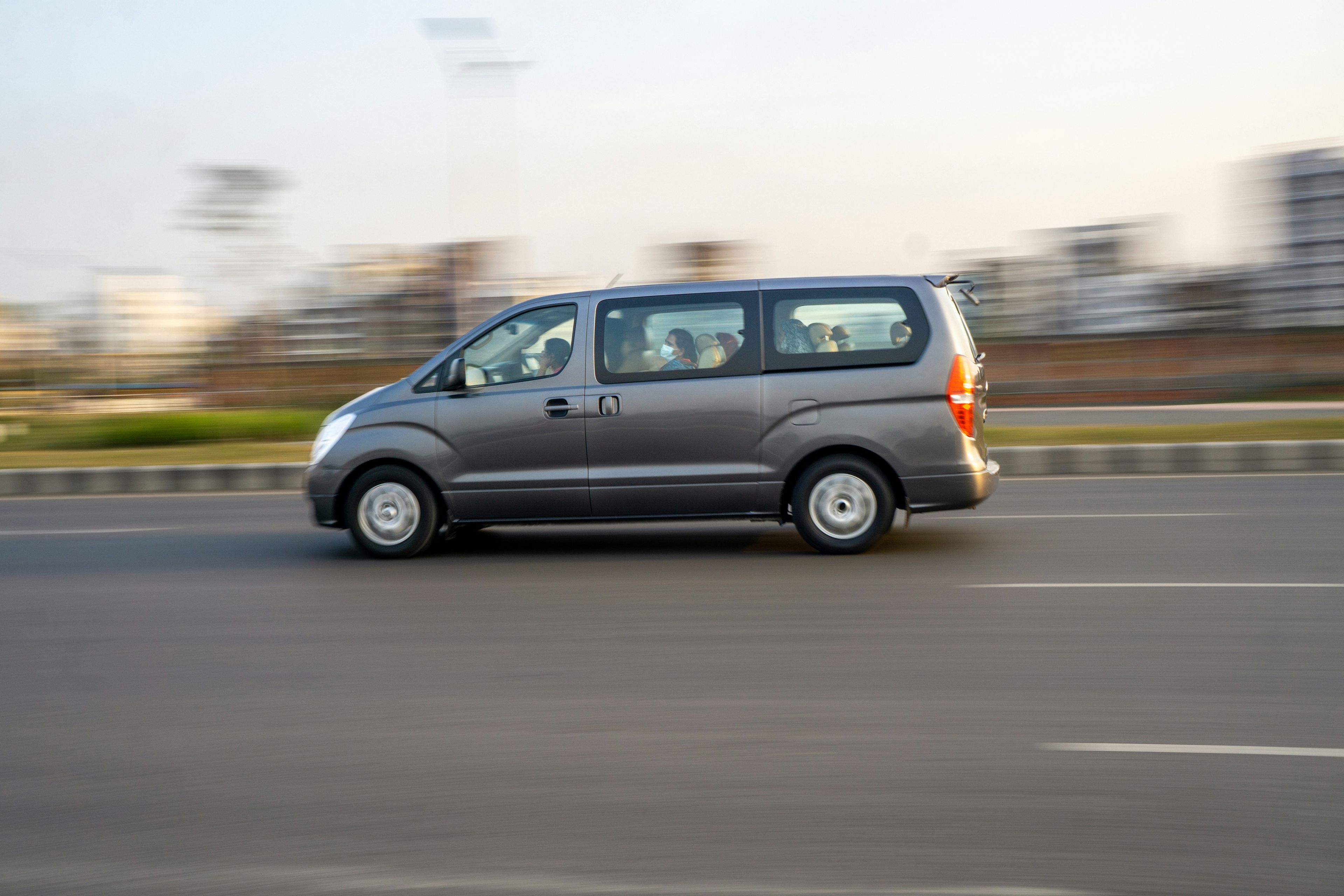 Grey Hyundai people-carrier captured in motion with panning blur