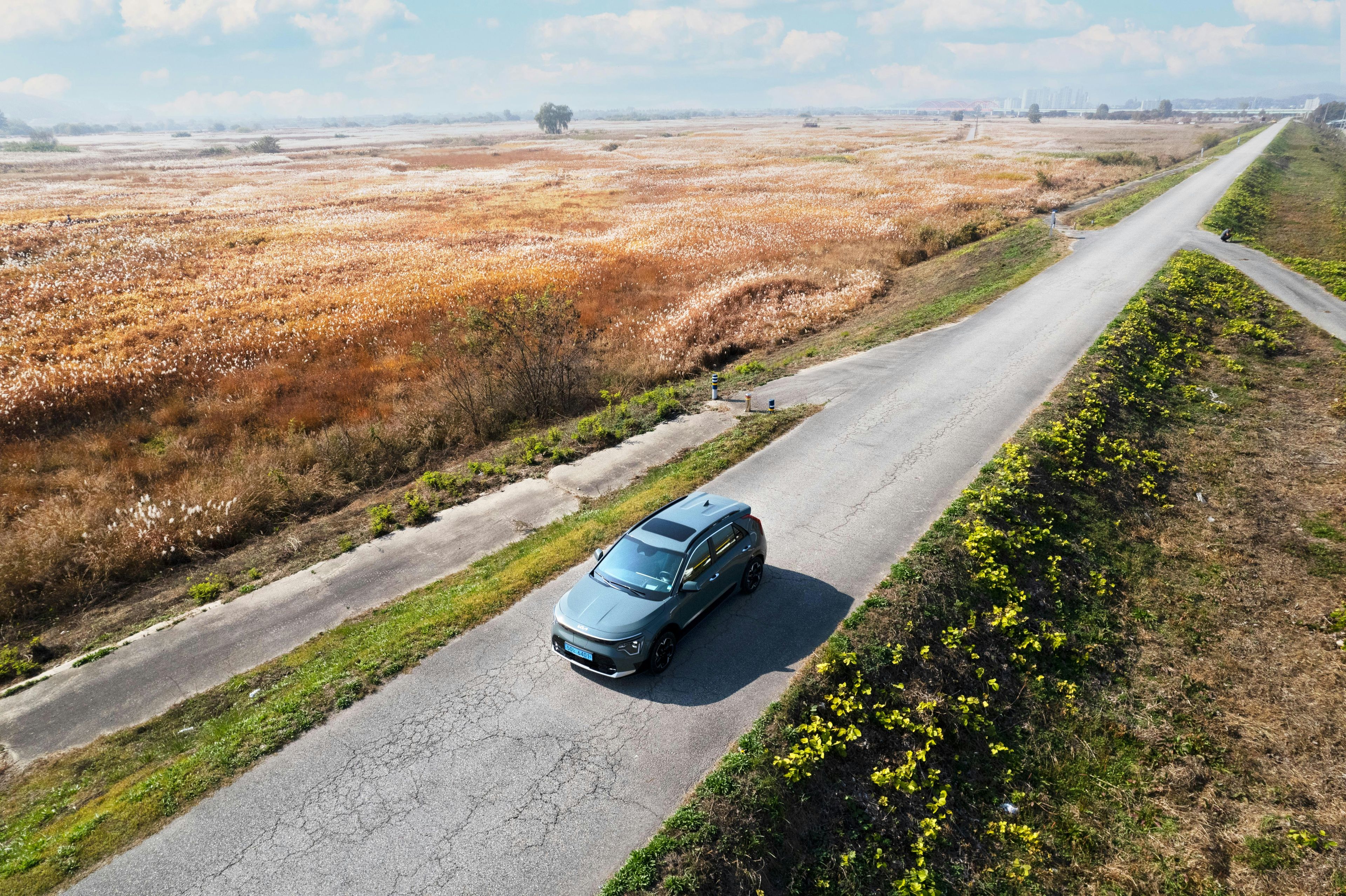 Aerial view of a grey crossover SUV on a rural road