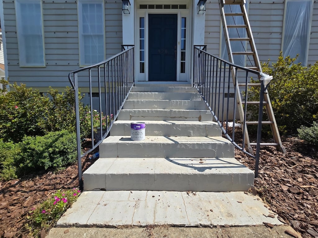 Preparation of a brick front porch and metal railings on Tanworth Drive in the Greystone neighborhood of Raleigh, NC, showcasing the technical cleaning and rust stabilization required for a durable professional finish.