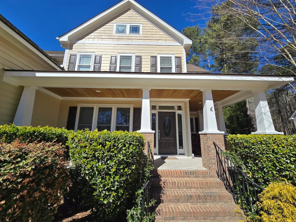 View from the front porch of a newly painted home in Cary, NC, showcasing the precise trim detailing and clean finish achieved through our professional exterior painting process.