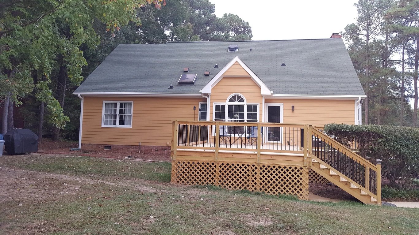 Residential exterior in Raleigh, NC, painted in Sherwin-Williams Rookwood Terra Cotta on Holly Drive, featuring UV-resistant pigments to ensure long-term color retention against North Carolina sun exposure.