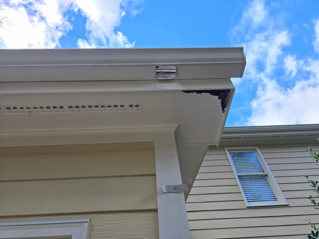 Technical illustration of soffit wood rot and water damage on a home on Possum Track Road in Raleigh, NC, caused by gutter overflow and chronic moisture entrapment requiring professional repair.