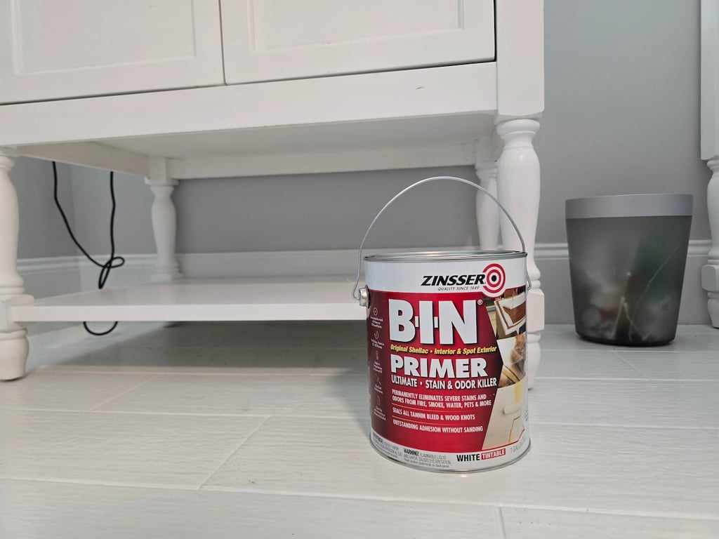 Professional application of Zinsser B-I-N shellac-based primer to kitchen cabinets in Raleigh, NC 27613, to seal wood tannins and create a high-adhesion bond for a factory-smooth finish.